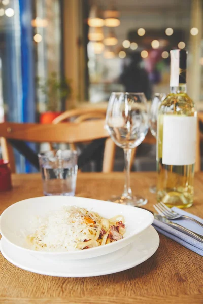 Hot Italian pasta with yolk and cheese served with wine — Stock Photo