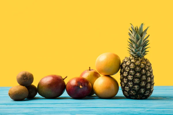 Close-up view of fresh ripe tropical fruits on yellow — Stock Photo