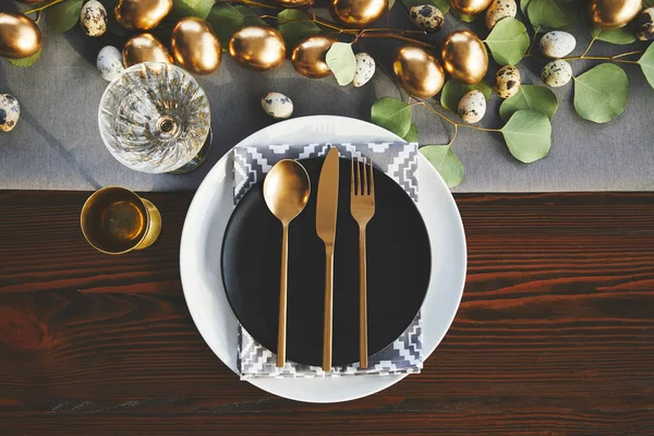 Top view of golden utensil on easter decorated table — Stock Photo