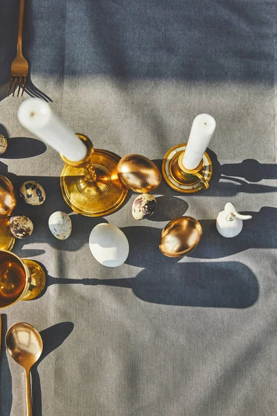 Top view of candles and easter eggs on festive table — Stock Photo