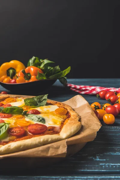 Close up of appetizing homemade pizza with cherry tomatoes and basil — Stock Photo
