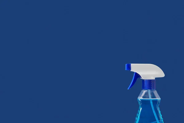 Spray for spring cleaning isolated on blue — Stock Photo