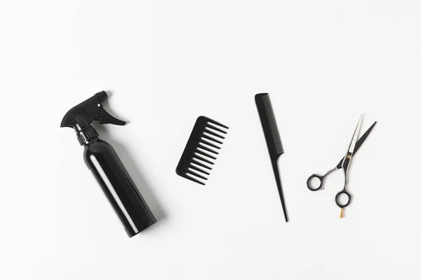 Top view of spray bottle, combs and scissors, on white — Stock Photo