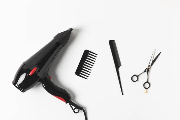 Top view of hair dryer, combs and scissors, on white — Stock Photo