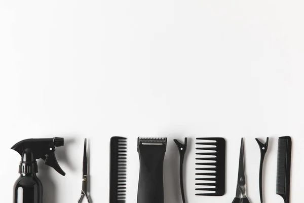 Top view of hair clipper and hairdressing tools in row, on white — Stock Photo