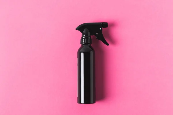 Top view of black spray bottle, isolated on pink — Stock Photo