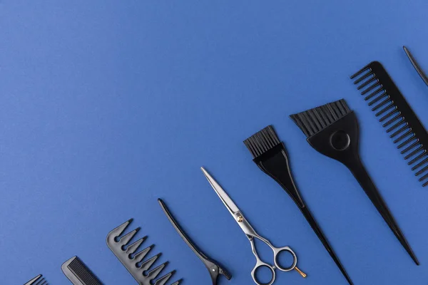 Composição diagonal com ferramentas de cabeleireiro, isolado em azul — Fotografia de Stock