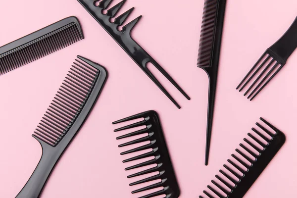 Top view of black combs, isolated on light pink — Stock Photo
