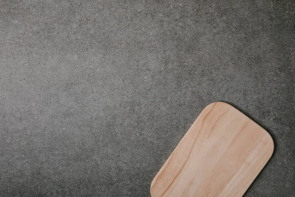 Top view of empty wooden cutting board on grey background — Stock Photo