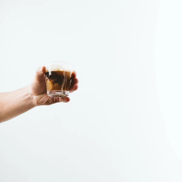 Abgeschnittene Ansicht von Hand haltenden Glas voller Kaffee mit Milch, isoliert auf weiß — Stockfoto