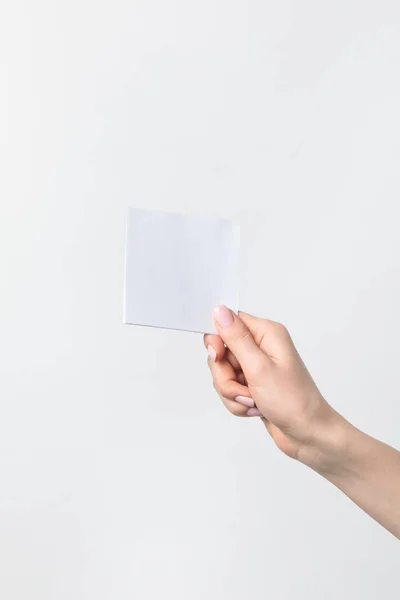 Cropped shot of woman holding blank note in hand isolated n white — Stock Photo