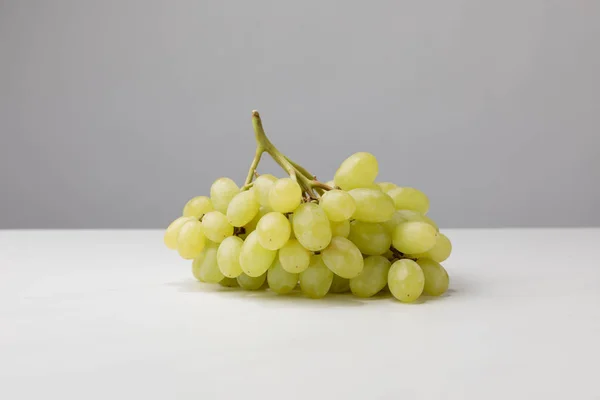 Close up view of pile of white grapes on gray — Stock Photo