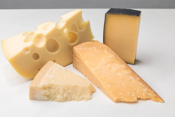 Vista de perto de diferentes tipos de queijo em cinza — Fotografia de Stock