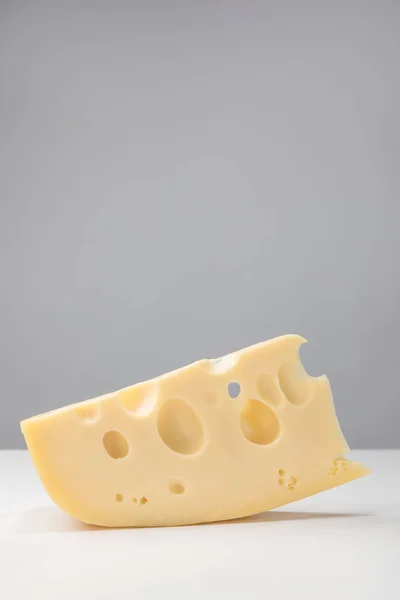 Close up image of maasdam cheese on gray — Stock Photo