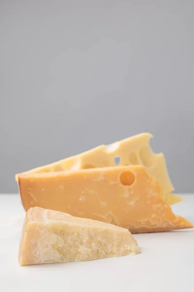 Close up shot of different types of cheese on gray — Stock Photo