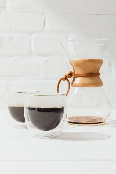 Closeup shot of alternative coffee in glass cups and chemex — Stock Photo