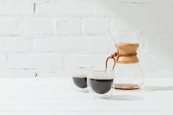 Two glass mugs with alternative coffee and chemex — Stock Photo