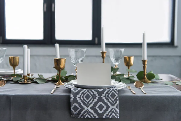 Close up view of empty card on plates on tabletop with beautiful rustic setting for guests — Stock Photo