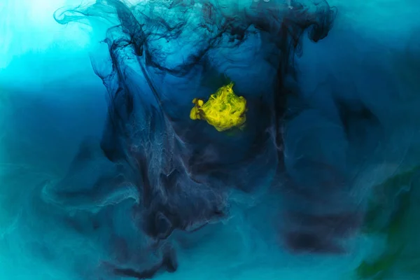 Full frame image of mixing of blue, black, yellow and green paints splashes in water — Stock Photo