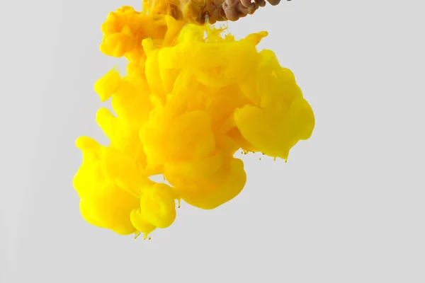 Close up view of bright yellow ink  splash in water isolated on gray — Stock Photo