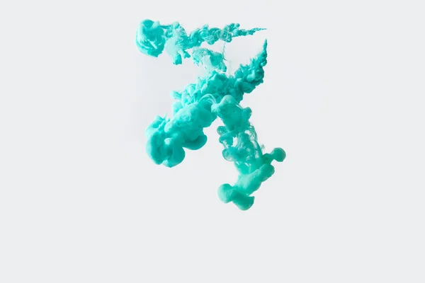 Close up view of bright turquoise paint splash in water isolated on gray — Stock Photo