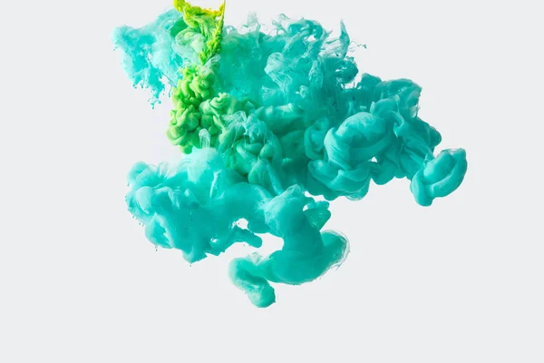 Close up view of mixing of green and bright turquoise paints splashes in water isolated on gray — Stock Photo