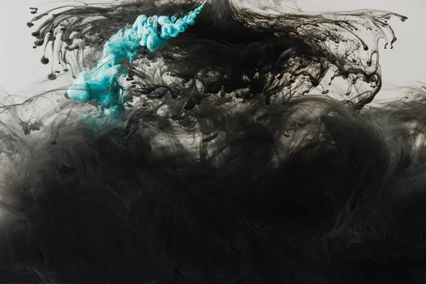 Close up view of mixing of light gray, turquoise and black paints splashes in water isolated on gray — Stock Photo