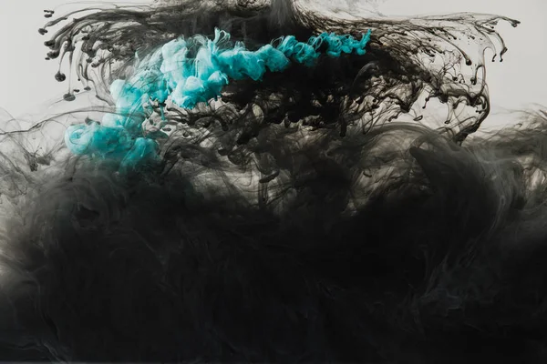 Close up view of mixing of light gray, turquoise and black paints splashes in water isolated on gray — Stock Photo