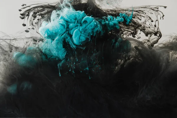Close up view of mixing of light gray, turquoise and black paints splashes in water isolated on gray — Stock Photo