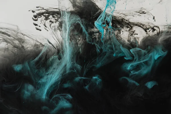 Close up view of mixing of light gray, turquoise and black paints splashes in water isolated on gray — Stock Photo