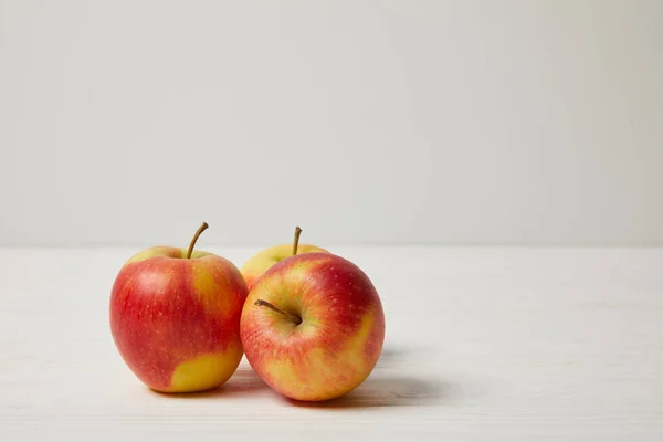 Raw fresh apples on wooden surface — Stock Photo