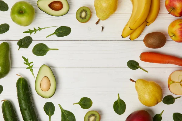 Top view of fruits and vegetables on wooden background with copy space — Stock Photo