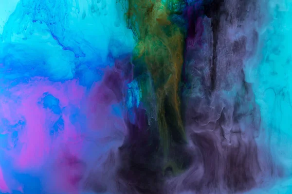 Creative texture with purple and blue paint swirls in water — Stock Photo