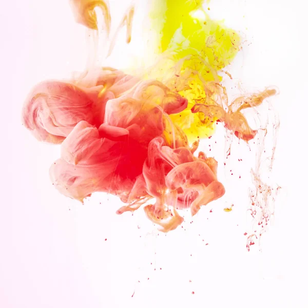 Splashes of smoky yellow and red paint, isolated on white — Stock Photo