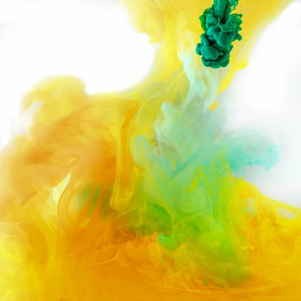 Abstract texture with green and orange watercolor paint in water — Stock Photo