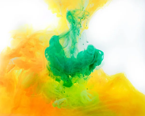 Smoky background with green and orange paint flowing in water — Stock Photo