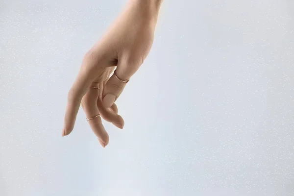 Cropped view of tender female hand with rings, isolated on grey — Stock Photo