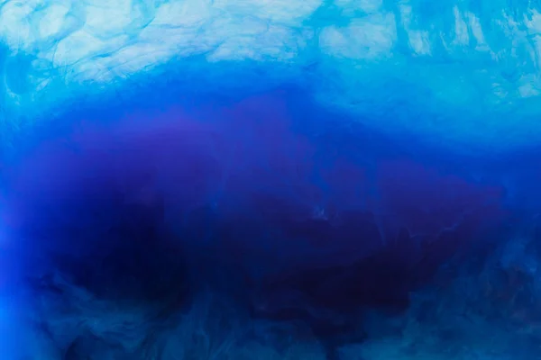 Abstract background with blue acrylic paint flowing in water — Stock Photo