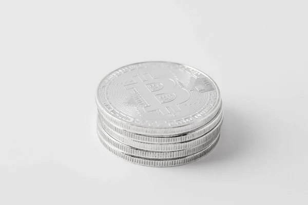 Close-up shot of stacked bitcoins on white surface — Stock Photo