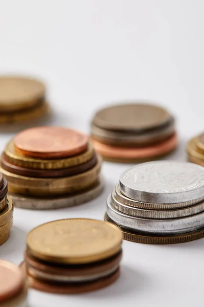 Close-up shot of stacks of various coins on white — Stock Photo