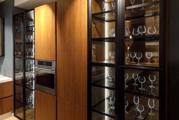 Interior of modern kitchen with glasses in cupboard — Stock Photo