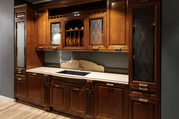 Interior de la cocina renovada con armarios de madera y lavabo - foto de stock