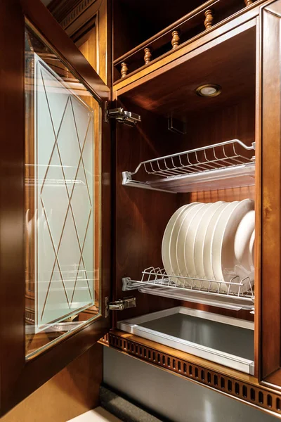 Stylish kitchen with white plates in cupboard — Stock Photo