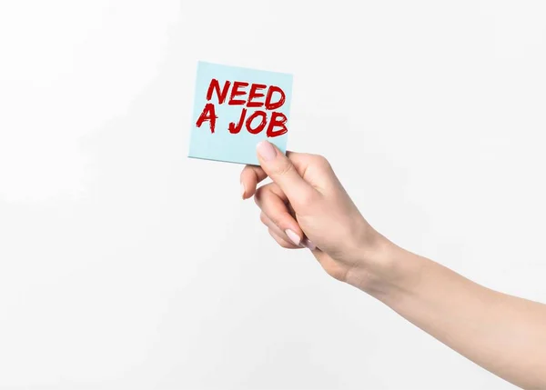 Cropped shot of woman holding blue sticky note with Need a job lettering, isolated n white — Stock Photo