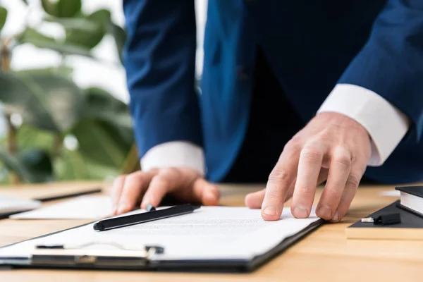 Vista parziale dell'uomo d'affari sul posto di lavoro con blocco note in ufficio — Foto stock