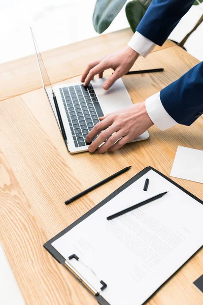 Plan recadré de l'homme d'affaires travaillant sur ordinateur portable sur le lieu de travail dans le bureau — Photo de stock