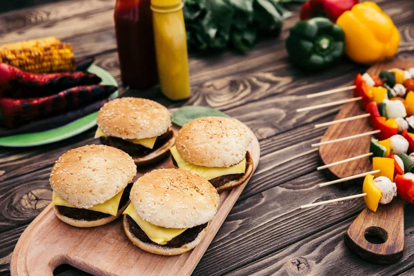 Hot delicious burgers and vegetables grilled for outdoors barbecue — Stock Photo