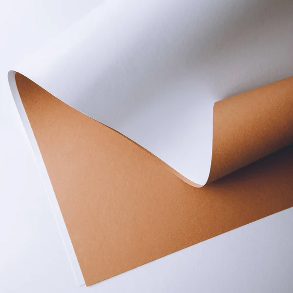 Close-up view of white and brown paper sheets on grey background — Stock Photo