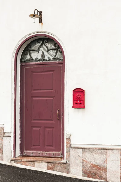Building with red door near vintage post box — Stock Photo