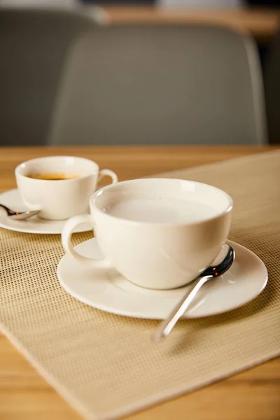 Selective focus of hot coffee in white cups — Stock Photo